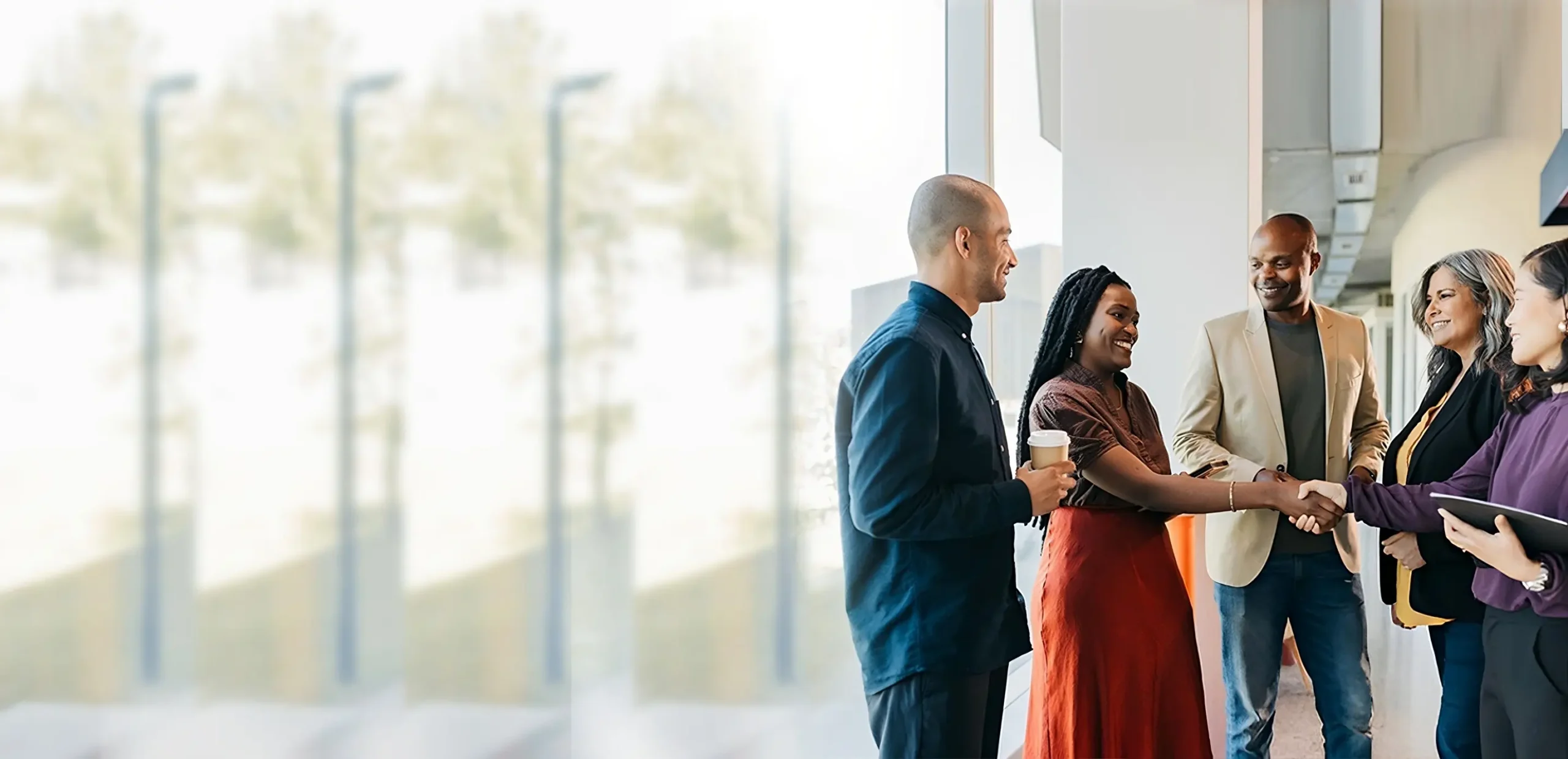people smiling and shaking hands